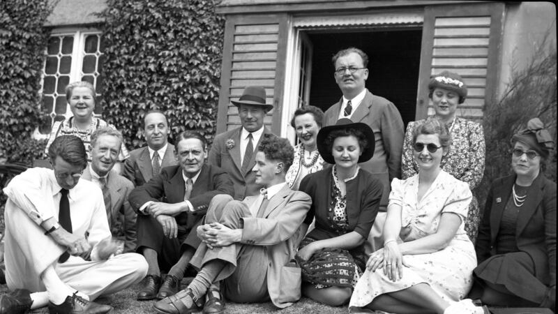 Desmond FitzGerald, second left, sits beside TS Eliot, with, sitting sideways, Fergus FitzGerald, taken in Lennox Robinson’s garden, June 30th, 1940. Photograph: The FitzGerald family collection
