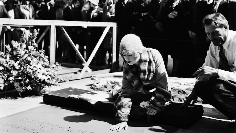 Actress Marion Davies (1897-1961) making her handprints in cement, along with her signature, outside Grauman’s Chinese Theatre in Hollywood, for MGM Studios, May 11th, 1929. Photograph: John Kobal Foundation/ Getty