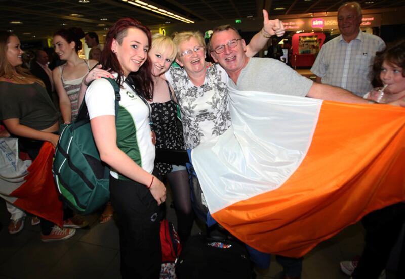Ellen - with sister Hazel, mum Laura and father Eddie - after returning home from the 2013 IPC World Championships with two bronze medals.