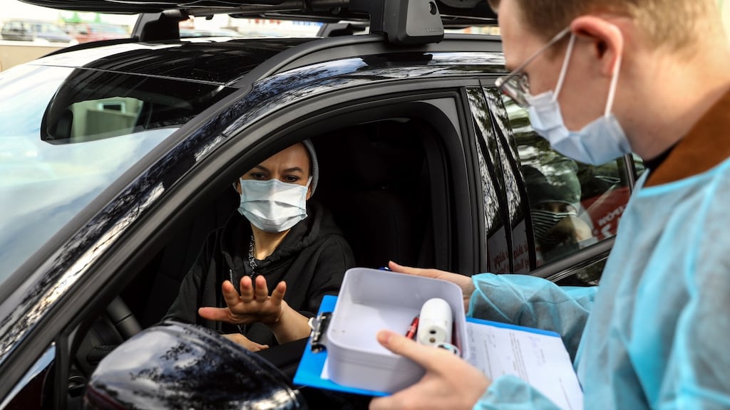 Drivers wait inside their cars to be immunised at the drive-through Covid-19 vaccination centre in central Poland. Photograph: Rafal Guz/EPA
