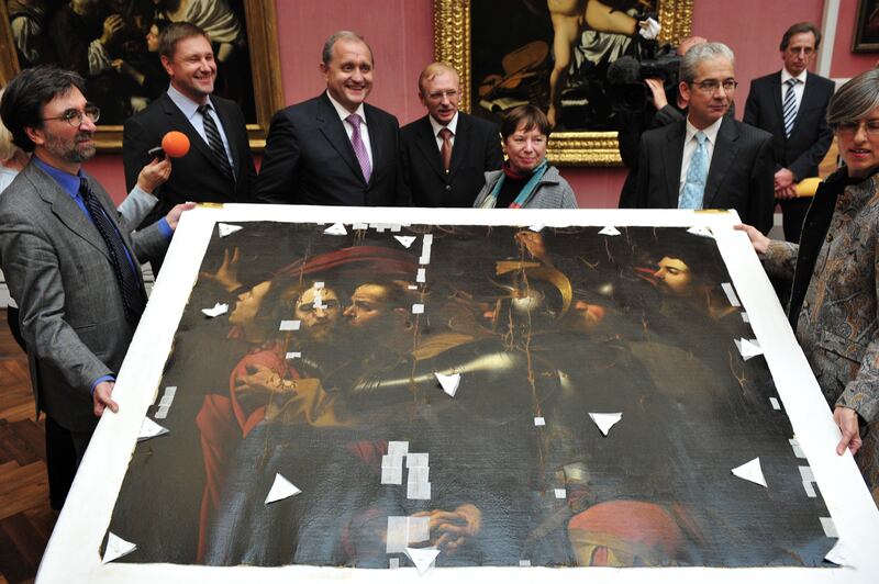 Ukrainian interior minister Anatoliy Mohilev (third left) and Berlin senator for justice Gisela von der Aue (fourth right) pose next to The Taking of Christ during a handover ceremony at a Berlin museum in August 2010. The painting, which was stolen from a Ukrainian museum in 2008 and recovered in Berlin in 2010, will be returned to the Ukraine after undergoing restoration work. Photograph: John MacDougall/Getty Images/AFP