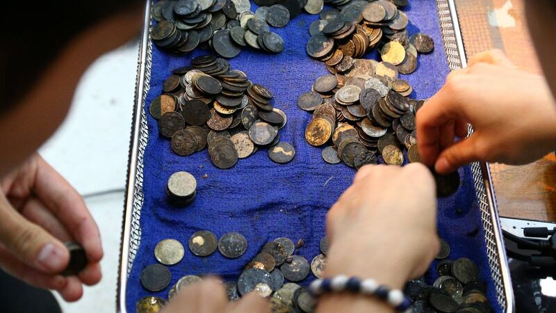 Officers count coins that were removed from the stomach of Omsin. Photograph: Athit Perawongmetha/Reuters
