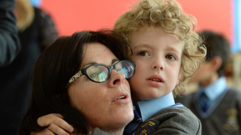 Harry Sweeney (4), Sandymount, holding onto his mother Aine during his first day at school at Star of the Sea primary school in Sandymount last month.    Photograph: Frank Miller/The Irish Times