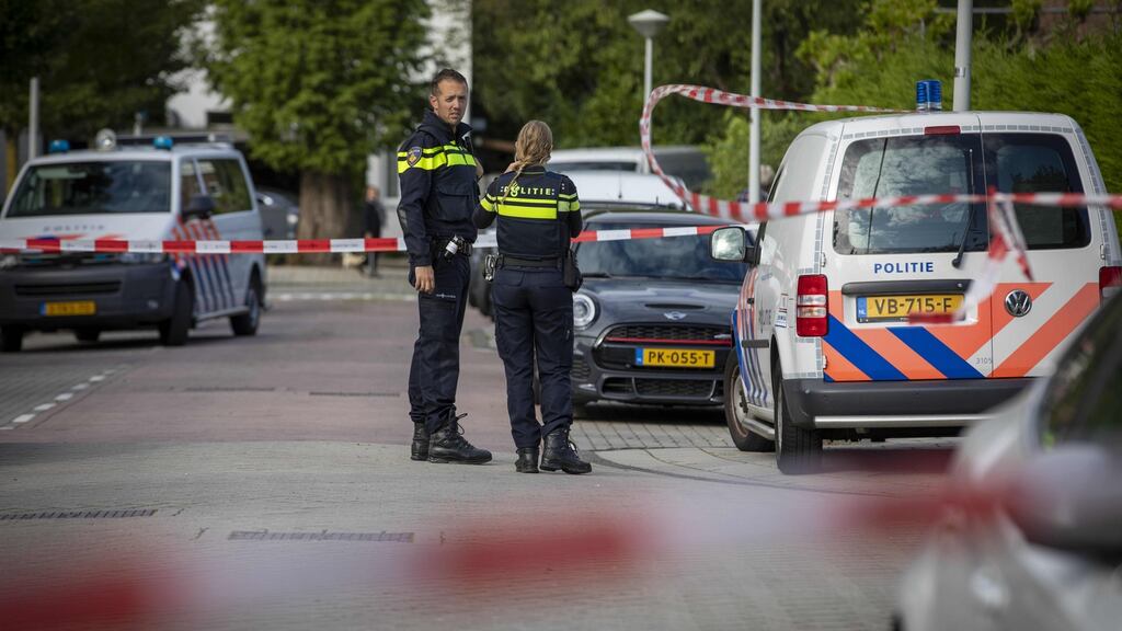 Police officers are seen near the site of an attack in Buitenveldert, in which Dutch lawyer Derk Wiersum was shot dead. Photograph: Michel van Bergen/ANP/AFP/Getty Images