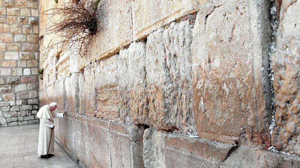 Commitment to brotherhood: the pope places a prayer in the Western Wall. Photograph: Menahem Kahana/AFP/Getty