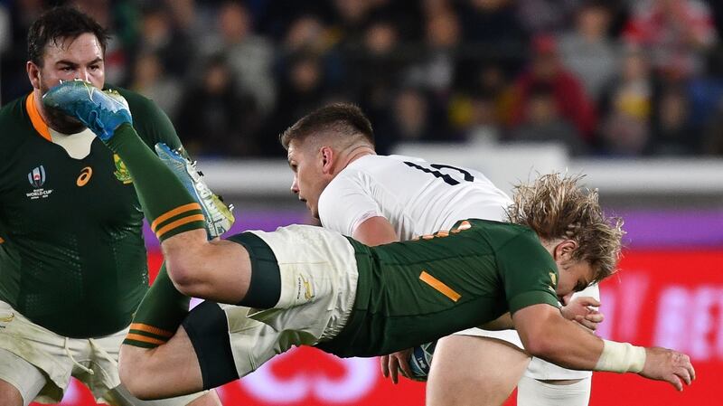 South Africa’s scrumhalf Faf de Klerk attempts a tackle on England’s Owen Farrell. Photograph: Kazuhiro Nogi/AFP/Getty