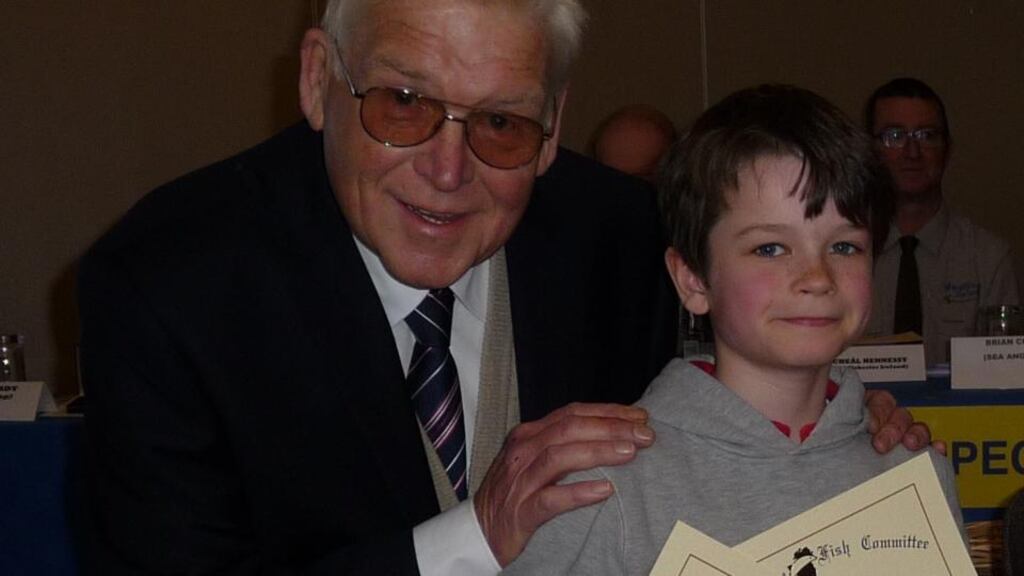 Mentor and master: As chairman of the National Inland Fisheries Ireland Forum, Derek Davis presents John Patrick Chew (9) with his fish certificates at the specimen awards day last February