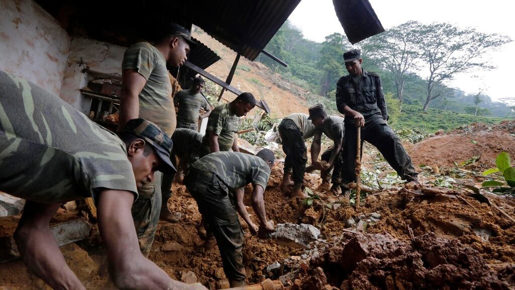 Sri Lanka armed forces personnel engage in rescue operations at the landslide area where 16 persons have been reported missing at Kalupahanawatte in Bulathkohupitiya, 97 kms towards the central hills from Colombo, Sri Lanka. Photograph: Pushpa Kumara/EPA