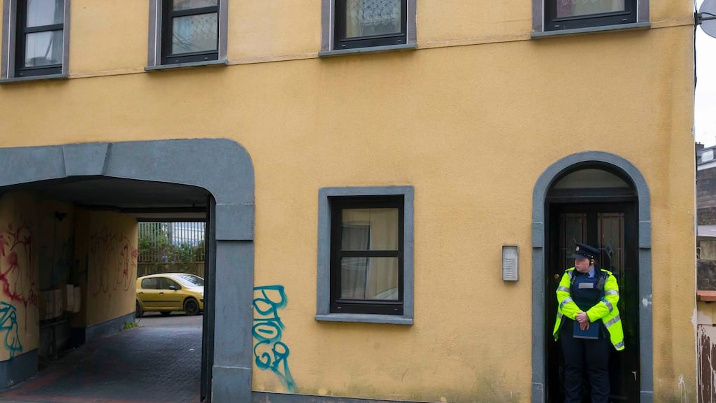 A garda outside the building where a woman’s body was found on Thomas Street, Waterford. Photograph: Patrick Browne
