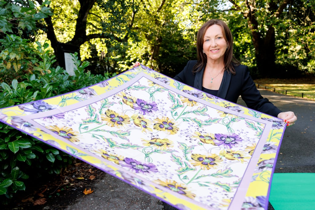 Brid O’Connell, chief executive of Guaranteed Irish, displays a scarf by Irish designer Caroline Duffy