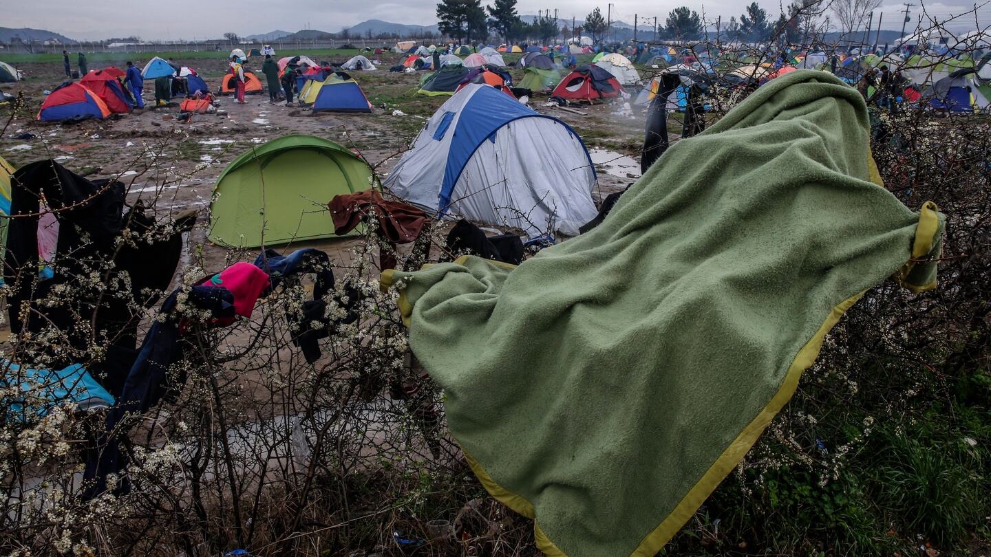 Refugees dry clothes in a camp at the border between Greece and Macedonia. Photograph: EPA