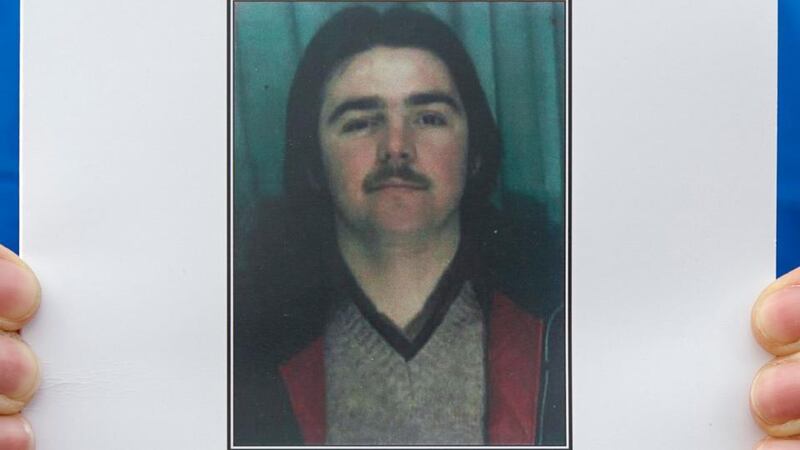A mourner holds the the funeral mass card of Disappeared victim Brendan Megraw at St Oliver Plunkett Church, Belfast today. Photograph: Liam McBurney/PA Wire