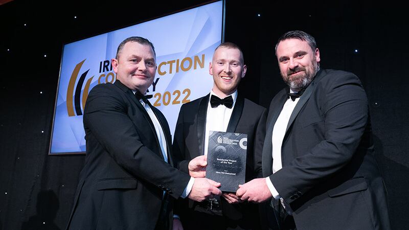 Neil Wall, head of Entries, BusinessRiver, presents the Residential Project of the Year award to Quentin Crinnigan and Kieran Meehan, T&I Fitouts.