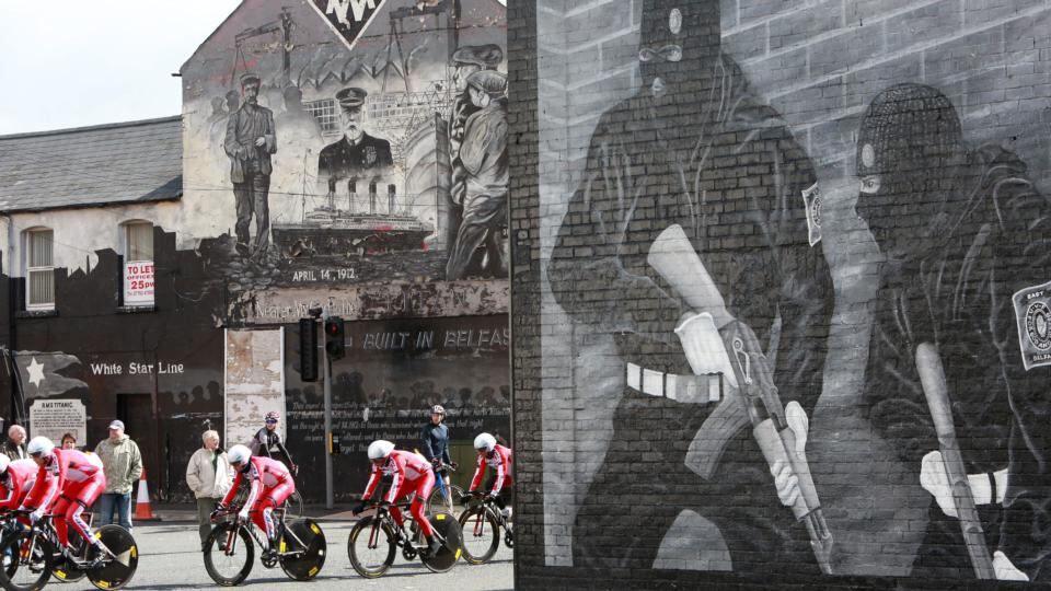 Riders of team Katusha cycle past pro-British Loyalist and Titanic murals of east Belfast during practice session. Photograph: Paul McErlane/EPA