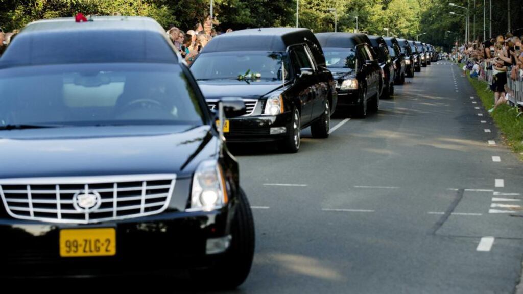 A convoy of hearses arrives at the Korporaal van Oudheusdenkazerne in Hilversum, Netherlands, yesterday. It is the fouth day that Dutch and Australian transport airplanes brought the remains from Charkov to the Netherlands, where the identification process will take place. Photograph: EPA