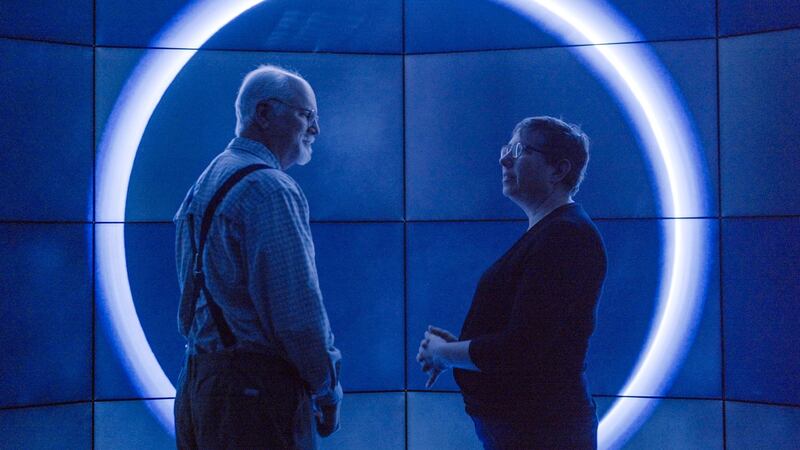 Planetary geologist Dr Geoffrey Moore and planetary astronomer Dr Leslie Young are viewing images of Pluto on a giant display in Pluto: Back From the Dead.  Photograph: Ben McGeorge-Henderson