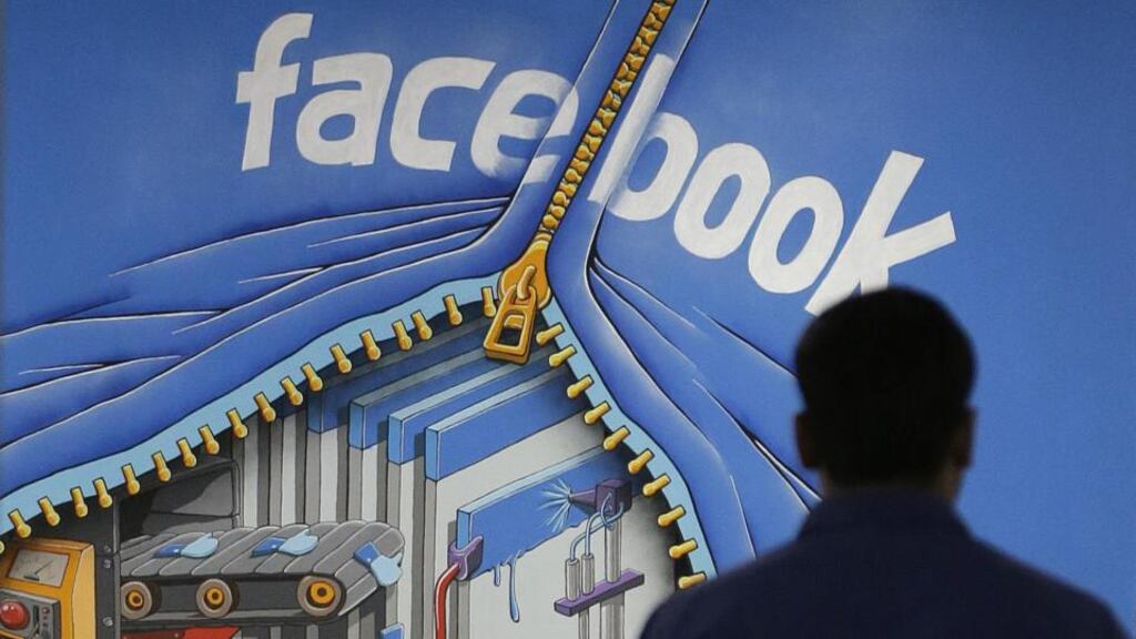 A Facebook employee walks past a sign at Facebook headquarters in Menlo Park, California.  “Like family in-laws, a friend of a friend might know a lot more about you than you would wish.”
Photograph: Jeff Chiu/AP