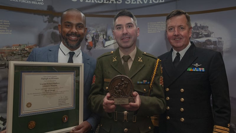 Sergeant Richard Muldarry of the Irish Defence Forces, centre, with his husband Levino de Oliveira and the Defence Forces chief of staff, vice admiral Mark Mellett DSM.