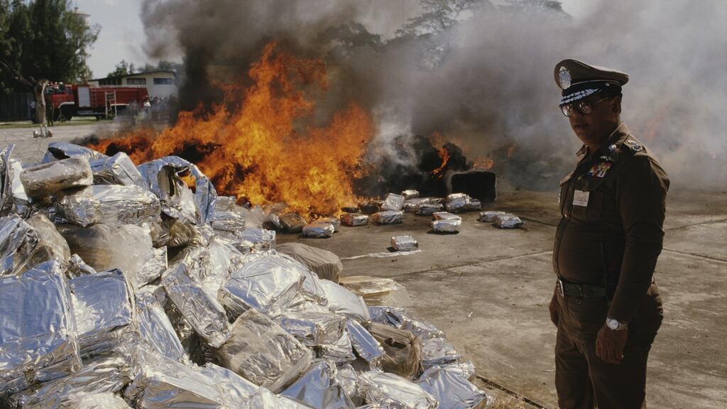 A soldier burns large parcels of confiscated illegal drugs in Thailand, circa 1987. Photograph: Robert Nickelsberg/Getty