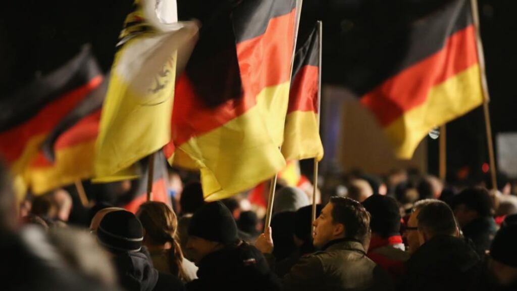 Supporters of the Pegida movement march with German flags at Monday’s demonstration in Dresden, Germany. Pegida is an acronym for ‘Patriotische Europaeer Gegen die Islamisierung des Abendlandes,’ which translates to ‘Patriotic Europeans Against the Islamification of the West,’ and has quickly gained a spreading mass appeal by demanding a more restrictive policy on Germany’s acceptance of foreign refugees and asylum seekers. Photograph: Sean Gallup/Getty Images
