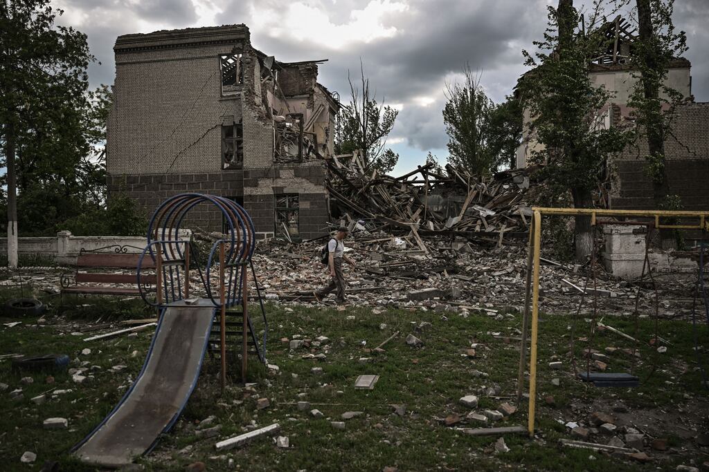A man walks in front of a destroyed school in the city of Bakhmut, in the eastern Ukranian region of Donbas. Photograph: Aris Messinis/AFP via Getty