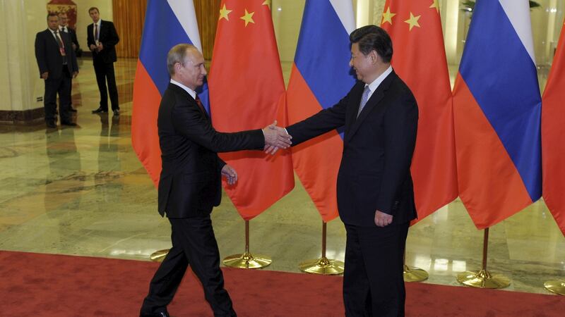 Chinese president Xi Jinping shakes hands with Russian president Vladimir Putin in Beijing in 2015. Photograph: Parker Song/Pool/Reuters