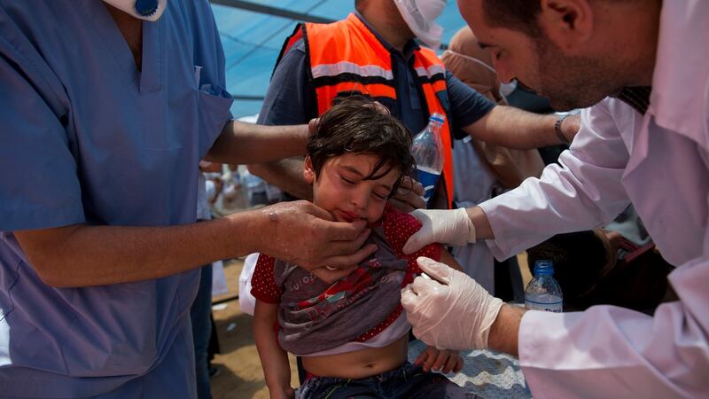 Medics treat a Palestinian child suffering from tear gas inhalation during a protest near Beit Lahiya, Gaza Strip, on Monday. Photograph: Dusan Vranic/AP