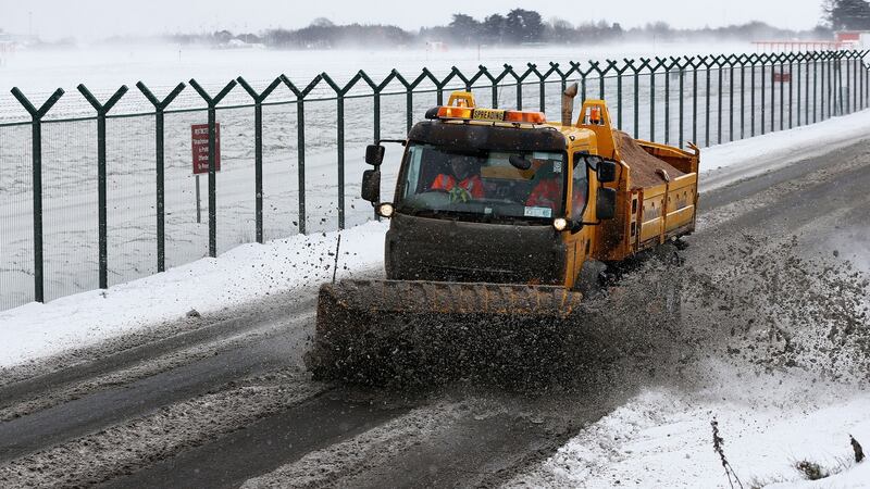 A snow plough clears a road at Dublin Airport today. Photograph: Brian Lawless/PA Wire