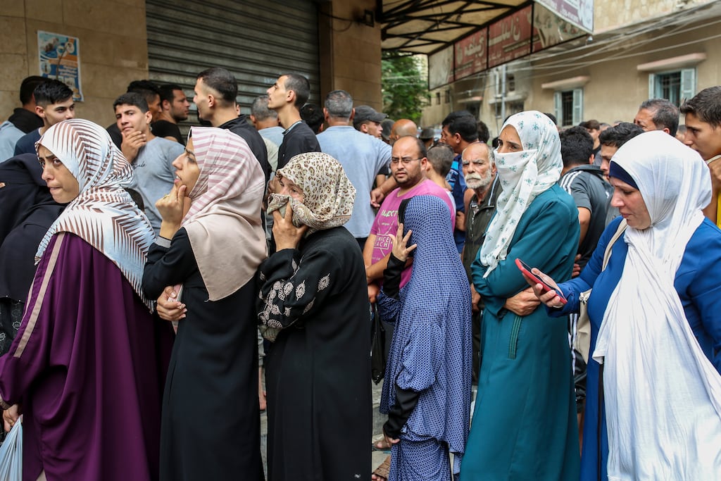 People wait in line outside a bakery to buy bread in the centre of Khan Younis, in the southern Gaza Strip. Photograph: Samar Abu Elouf/The New York Times