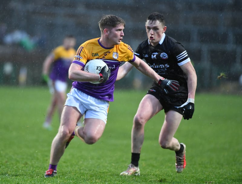 Aaron Jones of Derrygonnelly and Christopher Rooney of Kilcoo. Photograph: Andy Paton/Inpho