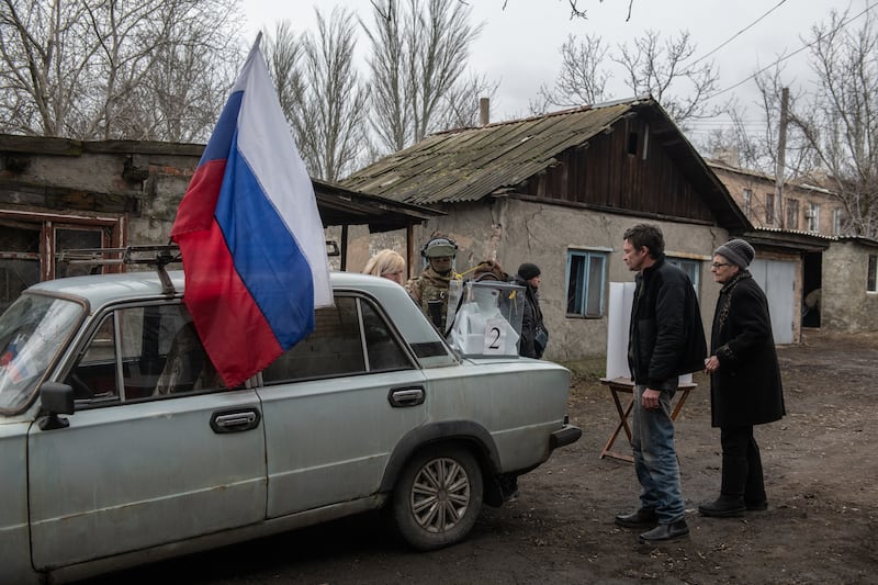 People vote at a mobile polling station during early voting in Russia's presidential election in Donetsk, Russian-controlled Ukraine. Photograph: Stringer/AFP/Getty Images