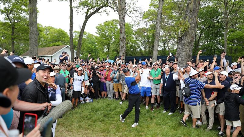 Koepka plays his second shot on the 13th hole from the gallery. Photo: Warren Little/Getty Images