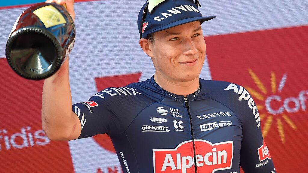 Team Alpecin’s Belgian rider Jasper Philipsen celebrates on the podium after winning the 2nd stage of the 2021 La Vuelta. Photo: Ander Gillenea/AFP via Getty Images