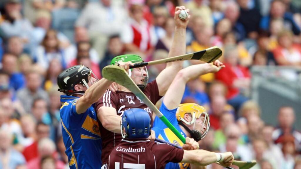 Joe Canning  claims a high ball in a crowded midfield in the 2010 All-Ireland Senior Hurling Championship quarter-final. Photograph: Donall Farmer/Inpho