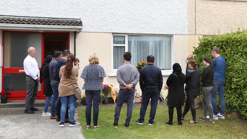 Friends, colleagues and neighbours place flowers outside the house where Karzan Sabah Ahmed, his wife Shahen Qasm and baby daughter Lina lived in Riverside, Co Galway. Photograph: Joe O’Shaughnessy