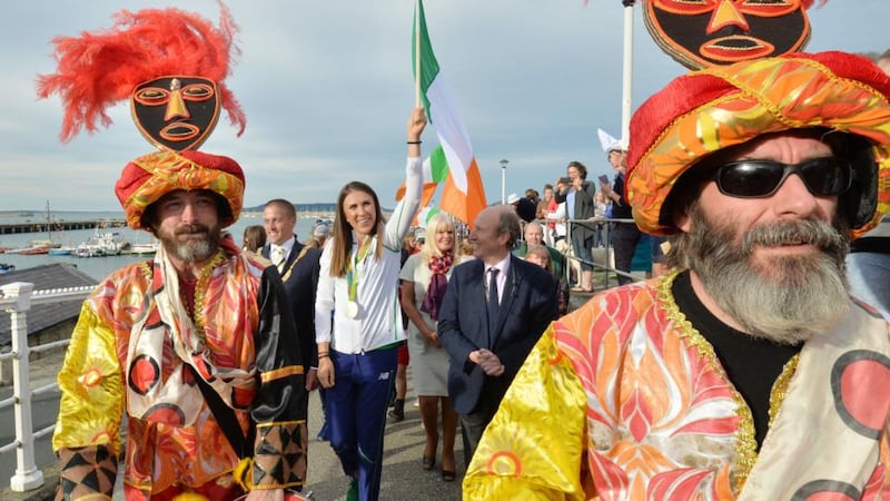 Silver medal-winning Olympian Annalise Murphy with Minister for Sport Shane Ross (to her left) after arriving on a flotilla of boats flanked by junior sailors for a homecoming in Dún Laoghaire harbour this evening. Photograph: Alan Betson/The Irish Times