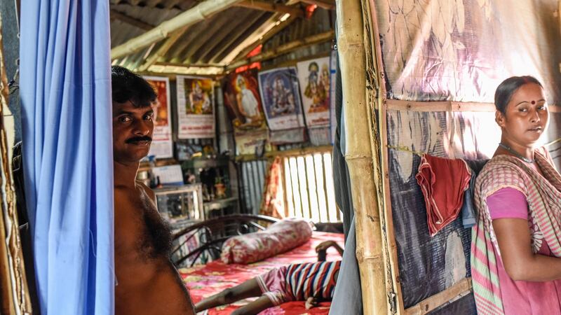 Gunadhar Mondol and his wife in their ramshackle home along a canal in Kolkata, India. Faced with the loss of their homes to flooding, many fisherfolk and rice farmers are abandoning the mangrove-rich delta region known as the Sundarbans, where the River Ganges meets the rising waters of the Bay of Bengal, for Kolkata. Photograph: Saumya Khandelwal/New York Times