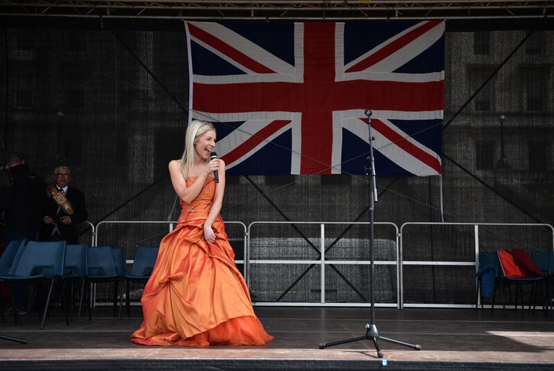 Soprano Clara Wilson, in a bright orange satin-silk ball gown, entertained the crowds. Photograph: Charles McQuillan/Getty Images)