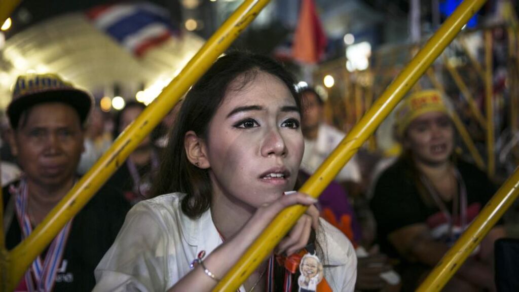 An anti-government protestor listens as leader Suthep Thaugsuban speaks about the elections during his daily speech in Bangkok,Thailand, on Monday. Photograph: Getty Images
