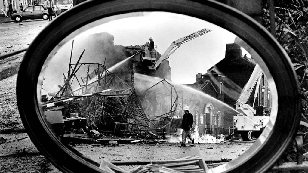 Photograph by Trevor Dickson: The police station on Lisburn Road was bombed on December 16th 1986. I noticed the houses across the road had been badly damaged and spotted a mirror on the lawn of one of them. It amazed me that it hadn’t been damaged and an idea came into my head right away. I propped the mirror against what was left of their garden pillar. I always tried to make something a little bit different, rather than the usual point and shoot