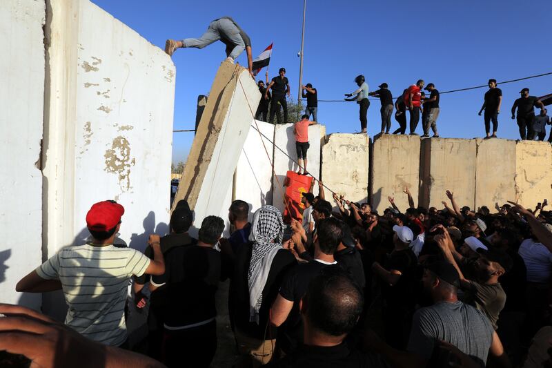 Supporters of Iraqi Shia cleric Muqtada al-Sadr, head of the Sadrist movement, storm the so-called 'Green Zone' in central Baghdad, Iraq, 27 July 2022. Photograph: Ahmed Jalil