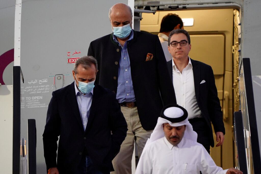 Emad Sharghi, Morad Tahbaz and Siamak Namazi, former prisoners in Iran, walk out of a Qatar Airways flight that brought them out of Tehran and to Doha, Qatar, on Monday. Photograph: Lujain Jo/AP/PA