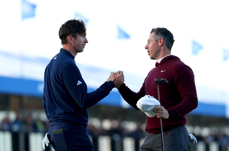 Tom McKibbin and Rory McIlroy shake hands after finishing their round on the 18th green during day one of this year's Irish Open. Photograph: Luke Walker/Getty Images