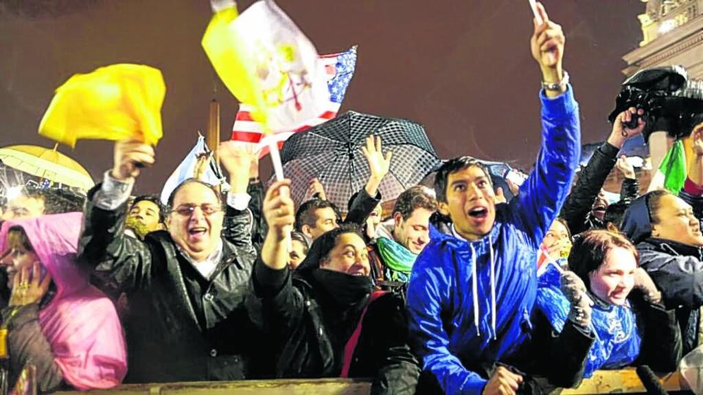 People celebrate as white smoke rises from the chimney on the roof of the Sistine Chapel. Photograph: Franco Origlia/Getty Images