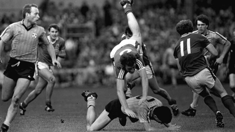 TJ Kilgallon of Mayo falls over Gerry Hargan of Dublin in the 1985 replay. Photograph: Inpho