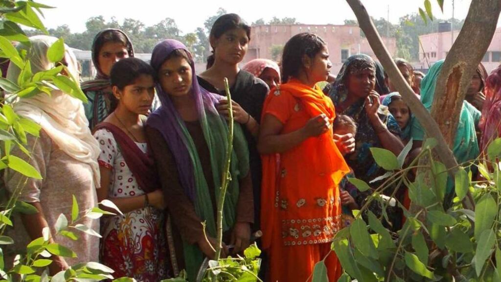 Onlookers look at the body of a woman, hanged from a tree, in Moradabad district in the northern Indian state of Uttar Pradesh yesterday. Photograph: Reuters