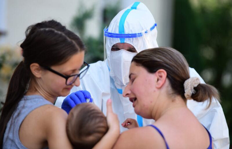 An employee of a mobile testing unit of the German Red Cross and German army Bundeswehr conducts a Covid-19 test with residents in Wiedenbrueck, western Germany on June 22nd. Photograph: Ina Fassbender/AFP via Getty