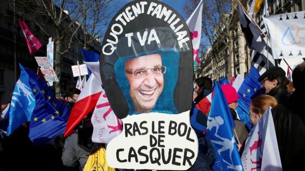 People gather in Paris last Sunday at the start of the “Manif pour tous” protest against France’s legalisation of same-sex marriage and to show their support of traditional family values. The sign protests at tax increases. Photograph: Reuters/Benoit Tessier