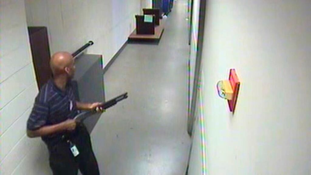 Aaron Alexis moves through the hallways of Building #197 carrying a Remington 870 shotgun. Photograph: FBI/Handout via Reuters
