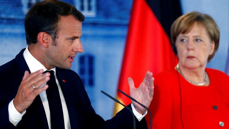 Emmanuel Macron and departing German chancellor Angela Merkel. Photograph: Hannibal Hanschke/Reuters